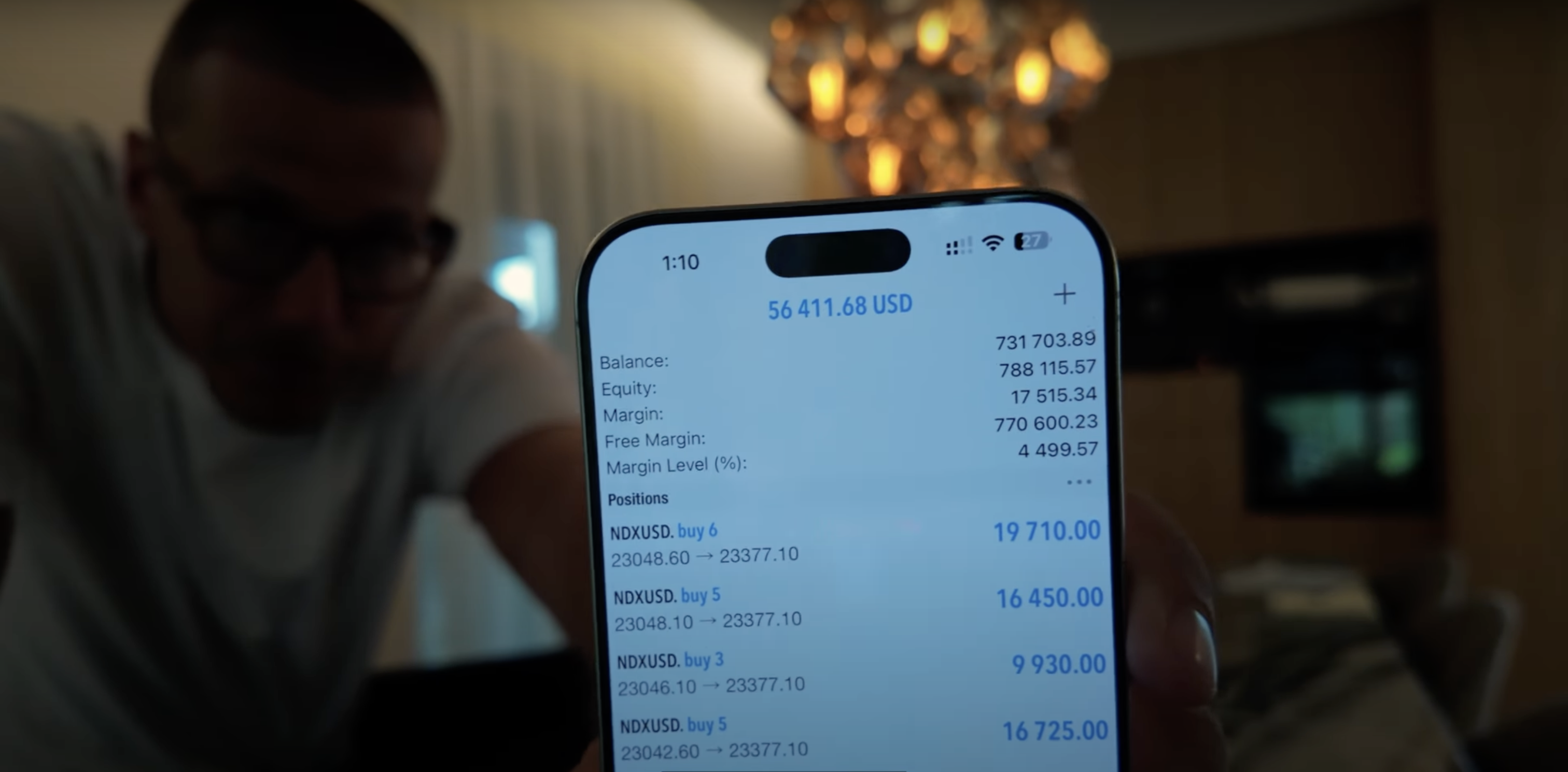 Photo — Jack holding phone with earnings